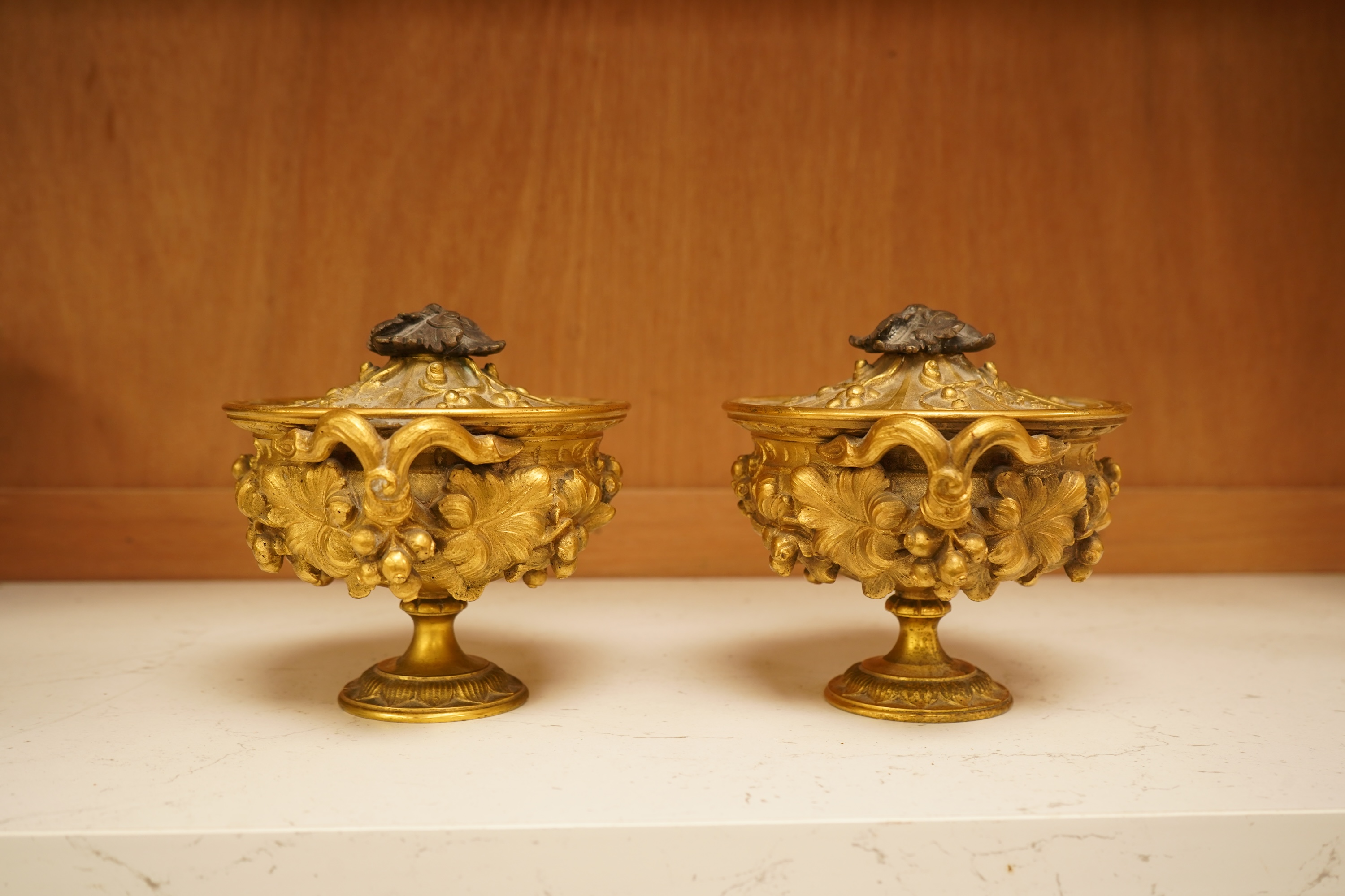 A pair of 19th century French ormolu lidded urns, 12cm